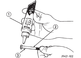 Fig. 104 Applying Sealer To Retainer And Housing Bolts